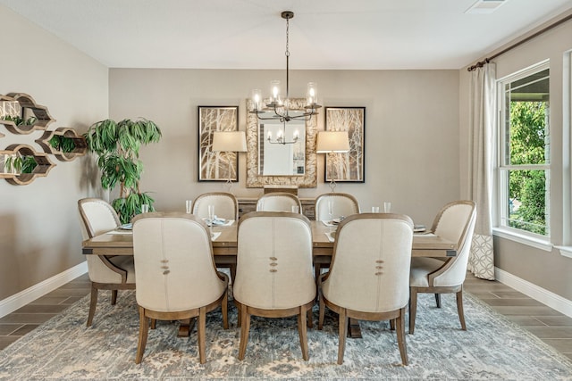 dining room featuring visible vents, baseboards, a chandelier, and wood finish floors