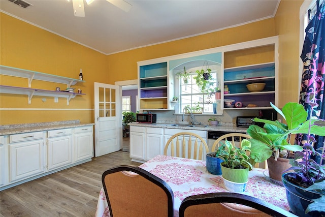 kitchen featuring light wood finished floors, open shelves, ornamental molding, white cabinetry, and a sink