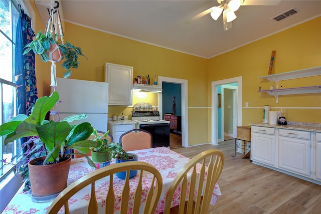 dining area featuring ornamental molding, visible vents, ceiling fan, and light wood finished floors