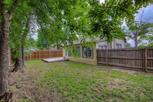 view of yard featuring a fenced backyard and a deck