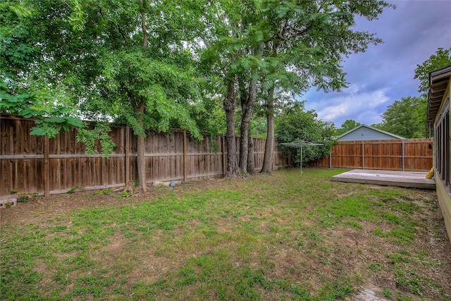 view of yard featuring a fenced backyard and a wooden deck