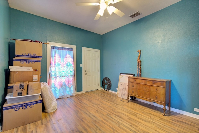 entrance foyer featuring visible vents, baseboards, and wood finished floors