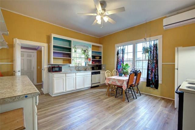 kitchen with range with electric cooktop, dishwasher, freestanding refrigerator, an AC wall unit, and a sink