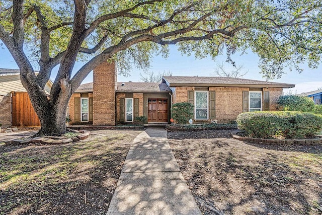 single story home with fence and brick siding