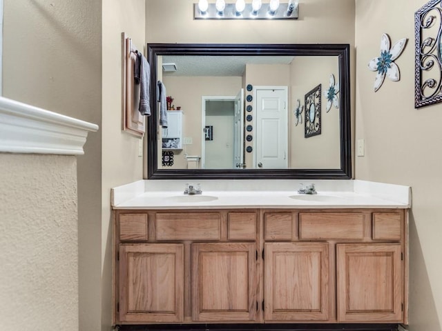 full bath with double vanity and a sink