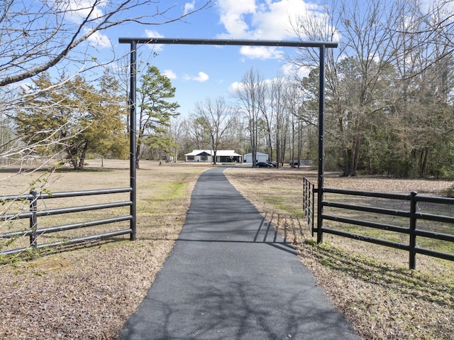 view of street featuring aphalt driveway, a gate, and a gated entry