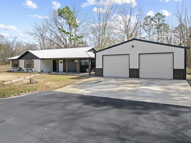 view of front of property with an outbuilding and metal roof