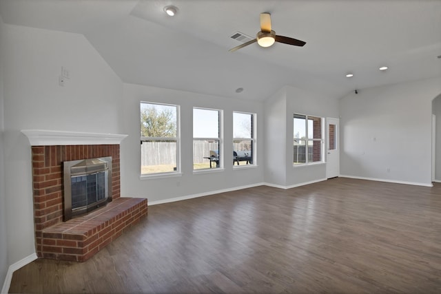 unfurnished living room with vaulted ceiling, visible vents, a fireplace, and dark wood-style flooring