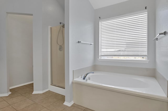 full bathroom featuring a stall shower, baseboards, a bath, and tile patterned floors