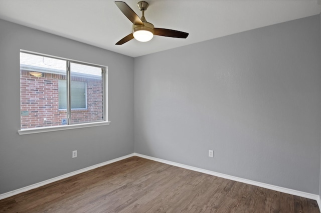 unfurnished room with ceiling fan, baseboards, and wood finished floors