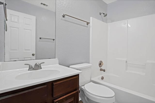 bathroom with visible vents, a textured wall, toilet, vanity, and shower / bathtub combination