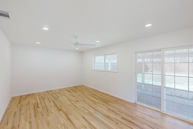 empty room with baseboards, visible vents, light wood-style flooring, and recessed lighting