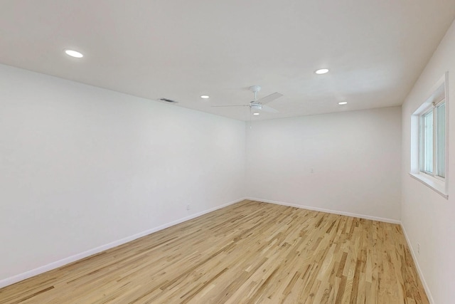 empty room featuring recessed lighting, visible vents, light wood-style floors, a ceiling fan, and baseboards