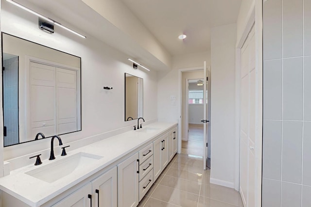 bathroom with double vanity, tile patterned flooring, a sink, and recessed lighting