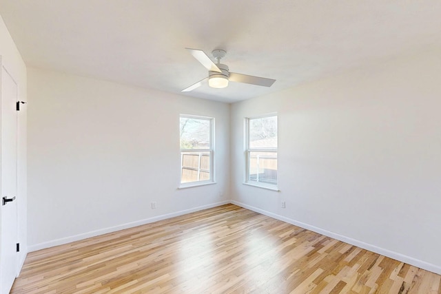 spare room featuring light wood-style floors, ceiling fan, and baseboards