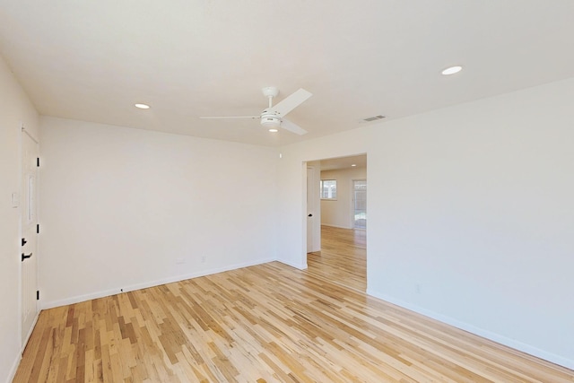 empty room featuring recessed lighting, baseboards, visible vents, and light wood finished floors