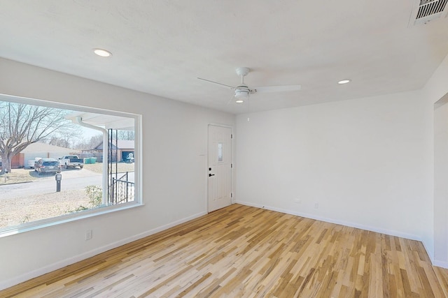 spare room featuring recessed lighting, baseboards, and wood finished floors