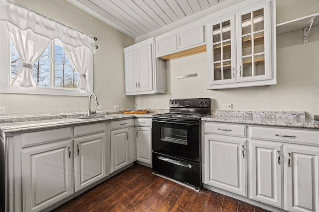 kitchen with a sink, glass insert cabinets, dark wood finished floors, and black range with electric stovetop