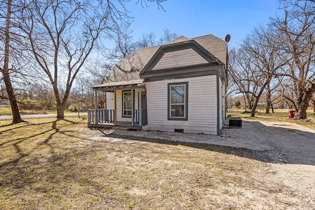 view of front of home with crawl space, covered porch, driveway, and roof with shingles