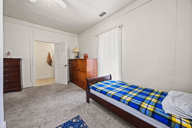 carpeted bedroom with visible vents and a ceiling fan