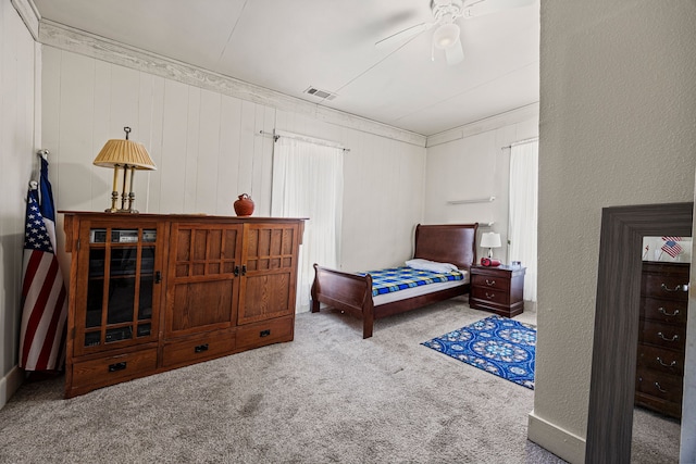 carpeted bedroom featuring a textured wall and visible vents