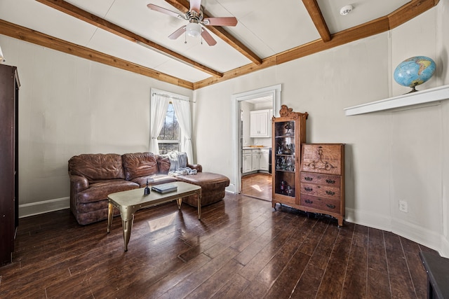 living room featuring wood-type flooring, baseboards, ceiling fan, and beam ceiling