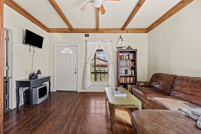 living area featuring ceiling fan, hardwood / wood-style floors, and beam ceiling