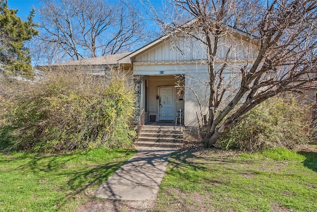 view of front facade featuring board and batten siding and a front yard