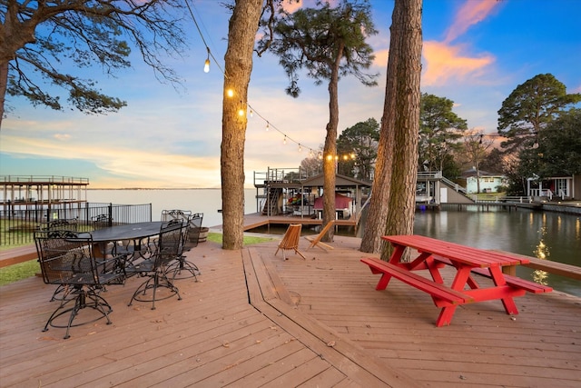 wooden terrace with a boat dock and a water view