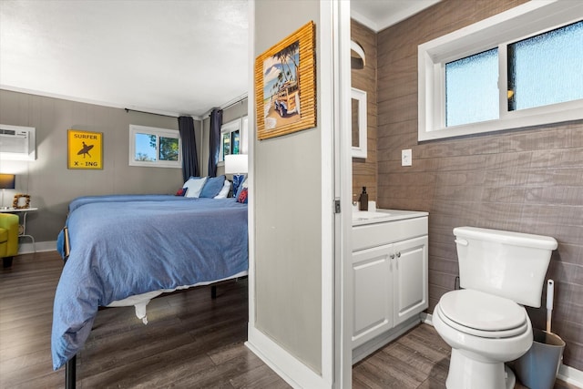 bedroom featuring dark wood-style floors and a wall mounted AC