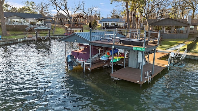 dock area with a water view, boat lift, and a residential view