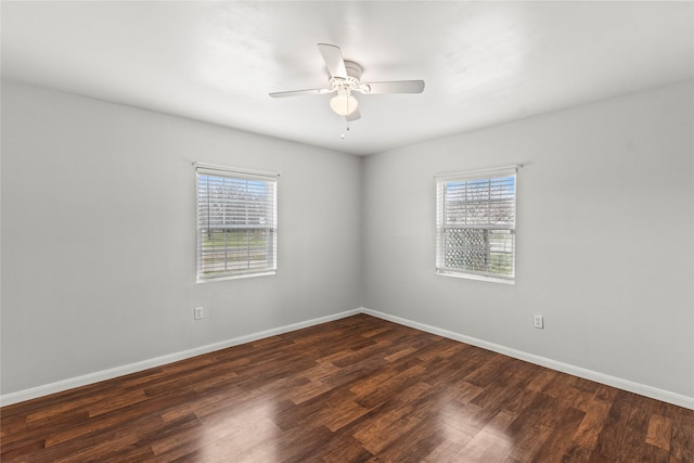 spare room with ceiling fan, baseboards, and wood finished floors