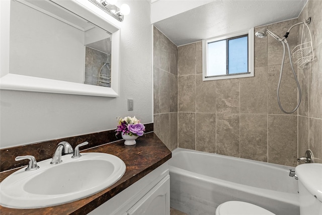 full bathroom featuring washtub / shower combination, vanity, and toilet