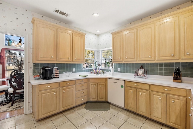 kitchen featuring light brown cabinetry, visible vents, dishwasher, and wallpapered walls