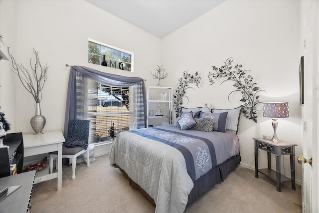 bedroom featuring light carpet, vaulted ceiling, and baseboards