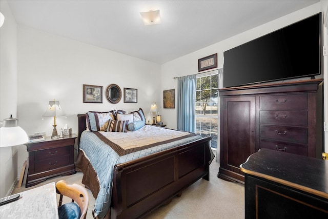 bedroom featuring light colored carpet