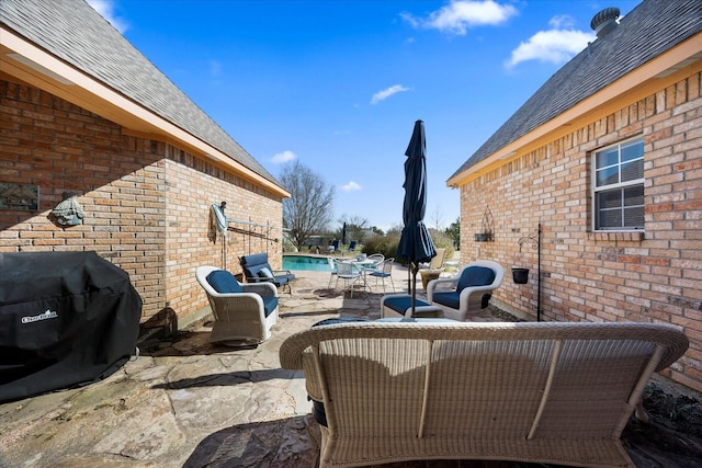 view of patio / terrace with an outdoor pool and area for grilling