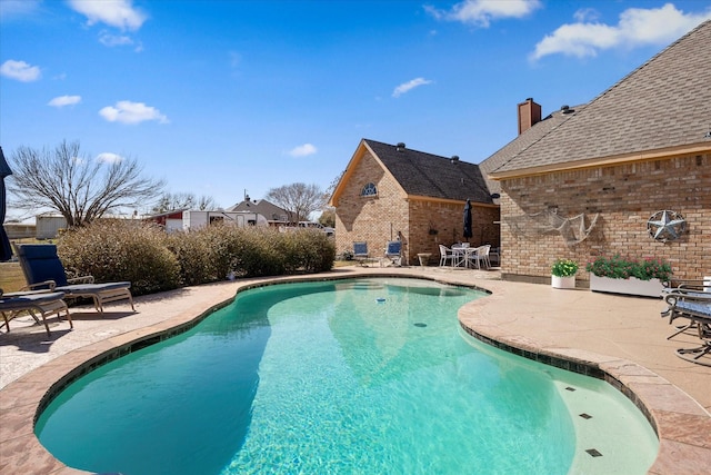 view of swimming pool with a fenced in pool and a patio