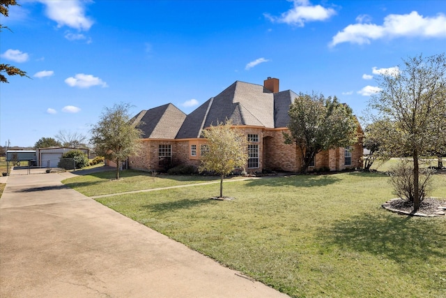 exterior space featuring a garage, brick siding, a lawn, and a chimney