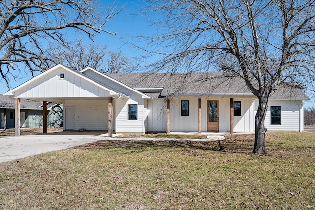 modern farmhouse style home featuring concrete driveway, a front lawn, board and batten siding, and roof with shingles