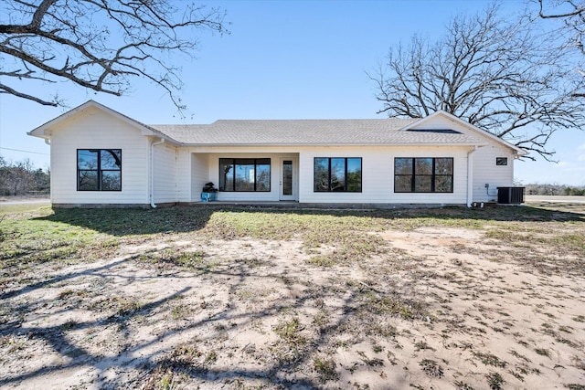 rear view of property with cooling unit