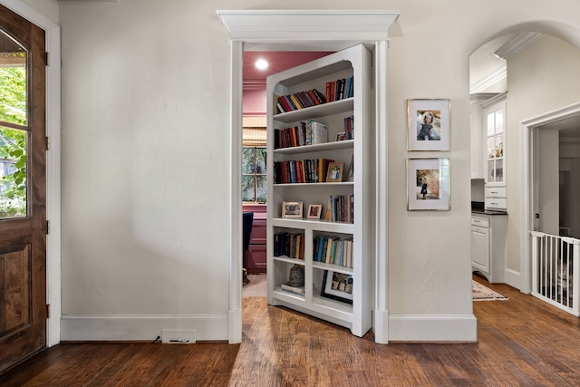 interior space with dark wood-type flooring and baseboards