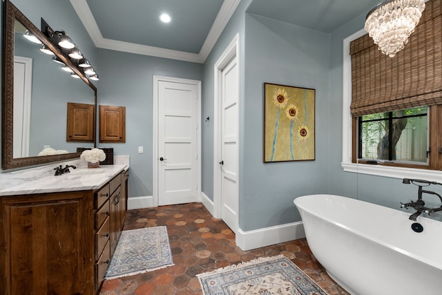 full bath featuring a freestanding tub, baseboards, crown molding, and vanity