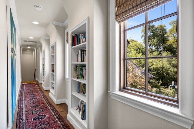 hallway featuring visible vents, wood finished floors, a wealth of natural light, and recessed lighting