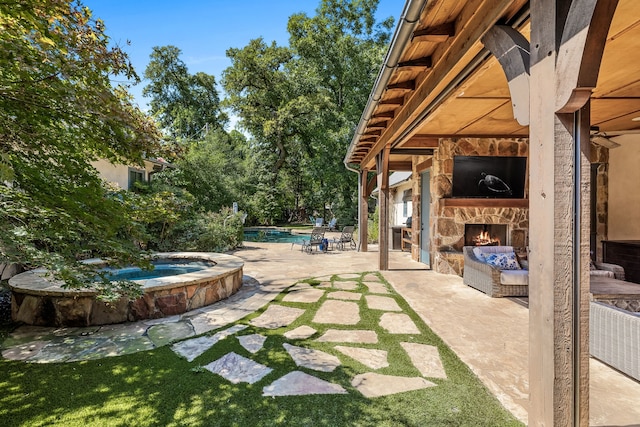 view of patio with an outdoor stone fireplace and an outdoor pool