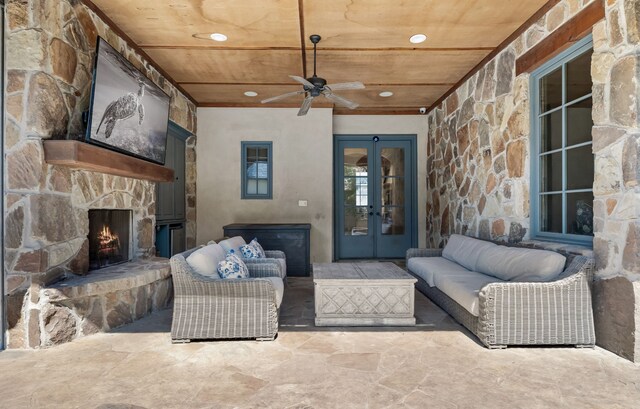 living area featuring ceiling fan, a stone fireplace, recessed lighting, wood ceiling, and french doors