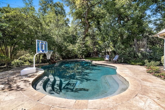 view of swimming pool with fence, a fenced in pool, and a patio