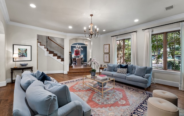 living area featuring stairway, a chandelier, wood finished floors, and ornamental molding