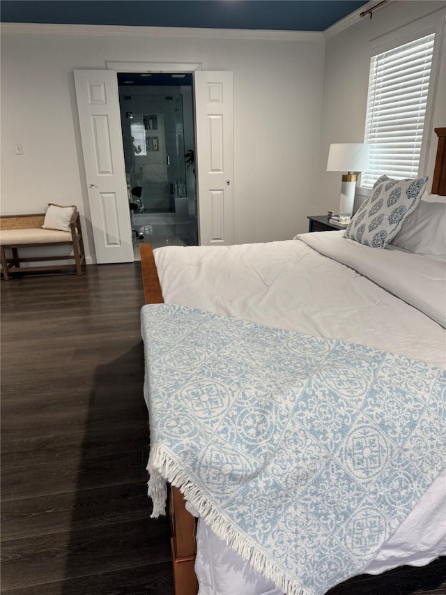 bedroom with dark wood-style flooring and crown molding