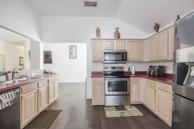 kitchen with visible vents, stainless steel appliances, a sink, and light brown cabinetry